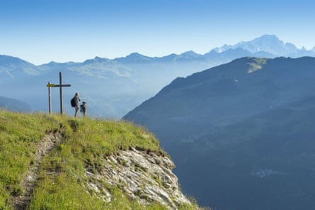 France, Savoie - two people gaze out into incredible view of valley and mountains