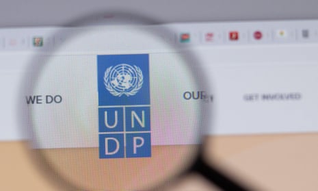 Magnifying glass over the United Nations Development Programme UNDP company logo