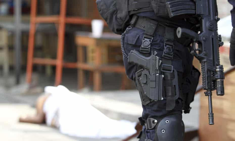 Police guard the scene of a murder after a man was shot to death in Acapulco, Mexico, on 2 January.
