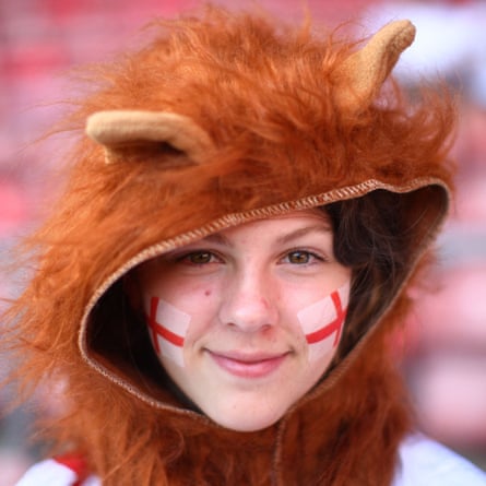 An England fan is pictured in fancy dress with face paint before the match.