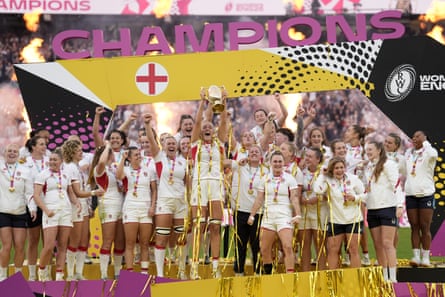 England’s players celebrate as Zoe Aldcroft lifts the Women’s Rugby World Cup trophy at Twickenham in 2025