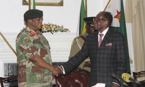 Robert Mugabe, right, shakes hands with General Constantino Chiwenga.