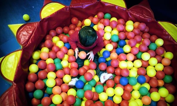 A child playing in a ball pool at a Sure Start centre in north London