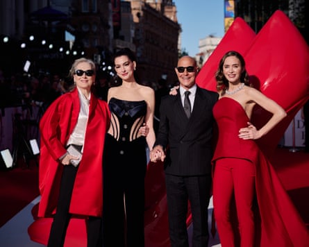 three women and one man on red carpet