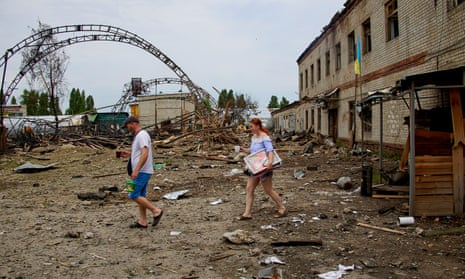 People take their belongings from a wood factory after a recent rocket attack on the outskirts of the small city of Bezlyudovka in the Kharkiv area, Ukraine.