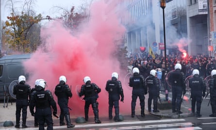 Flare set off near police officers at a protest in Brussels