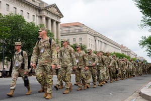 soldiers walk along a street