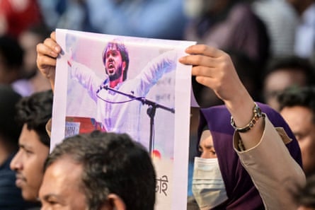 An activist holds a poster of Sharif Osman Hadi