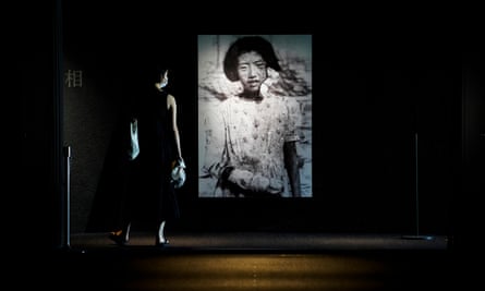 visitor looks at photographs of the Hiroshima bombing survivors, at the Hiroshima Peace Memorial museum.