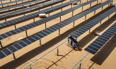 Lines of solars panels on a sandy floor