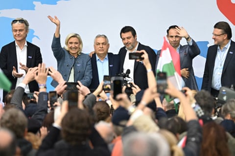The group stand on stage at a rally