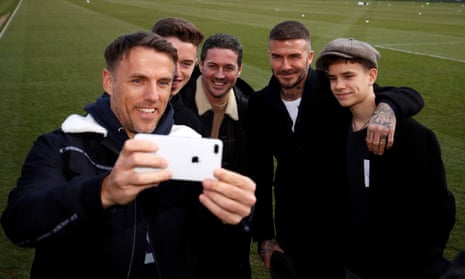 Phil Neville (left) takes a photo with his son Harvey, sports agent Dave Gardner, and David and Romeo Beckham at Salford City’s ground in 2019.