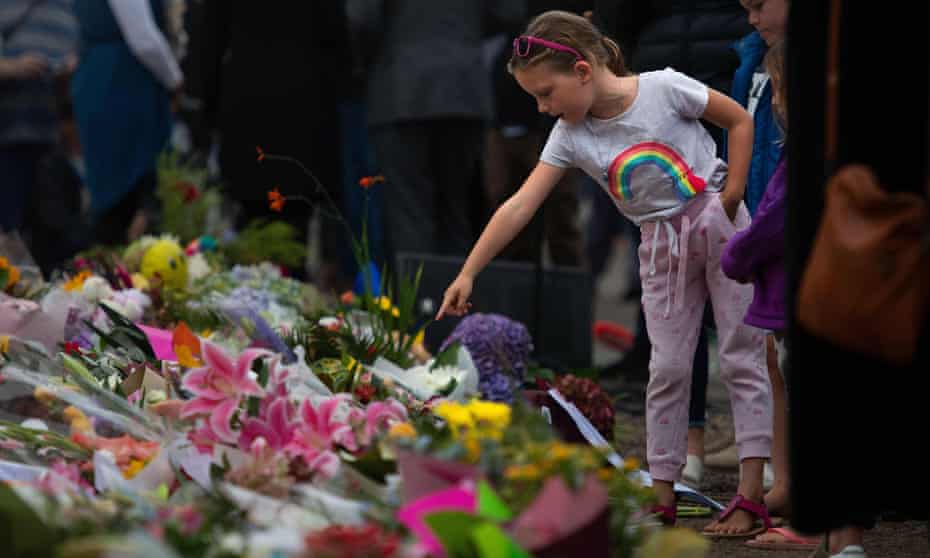 People pay their respects at a memorial site in Christchurch