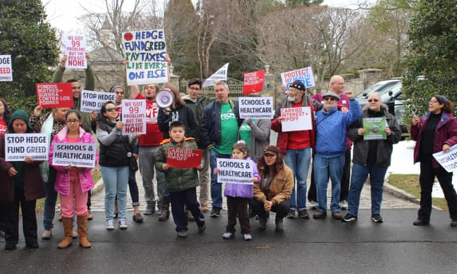 Protesters with the ‘Lifestyles of Rich &amp; Shameless’ bus tour outside billionaire Steven Cohen’s mansion in Greenwich, Connecticut.