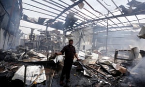 An employee stands in the bomb-damaged factory in the capital’s Nahda district