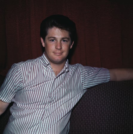 Young Brian Wilson in a striped shirt, smiling