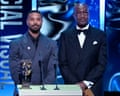 Michael B Jordan and Delroy Lindo presenting an award on stage at the Baftas