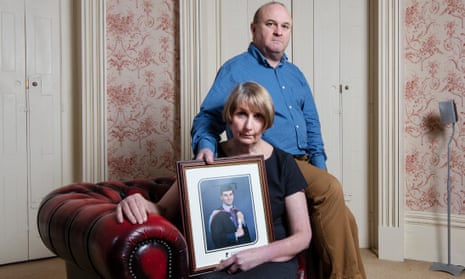 Ray and Alison Johnson with a photo of their son Elliott, who was found dead earlier this year