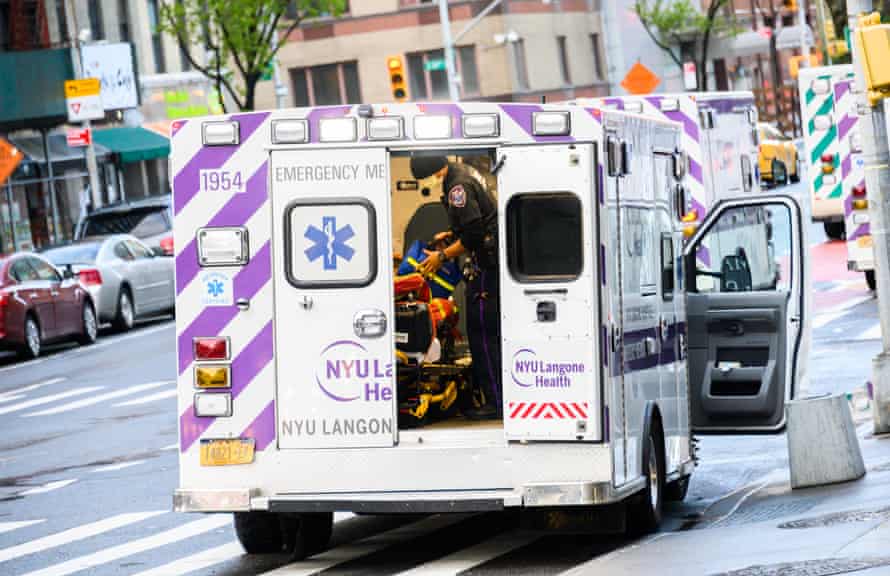 EMS worker is seen outside NYU Langone Health hospital in New York City.