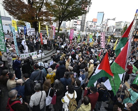 A large group of people holding flags and banners