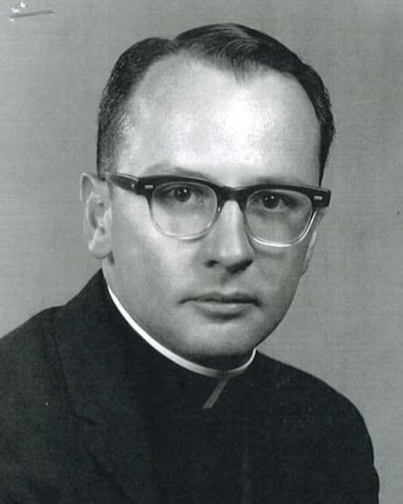 A black and white photo of a young priest.