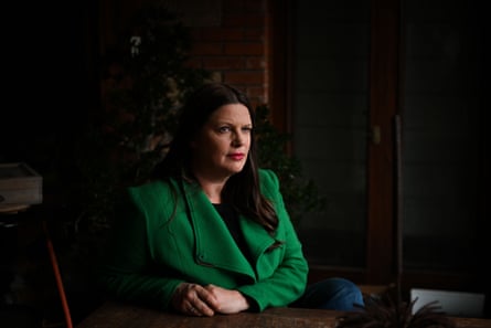 A portrait of a woman wearing a green blazer