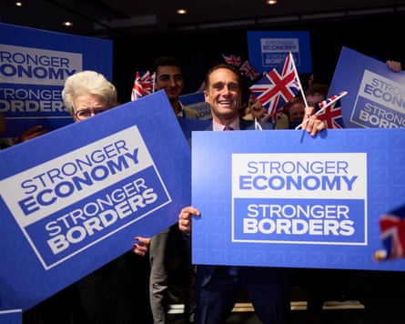 Supporters wave placards at conference