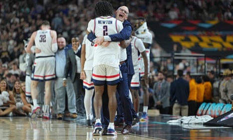 Connecticut Huskies head coach Dan Hurley hugs guard Tristen Newton as the team make their way to victory in the NCAA Tournament final