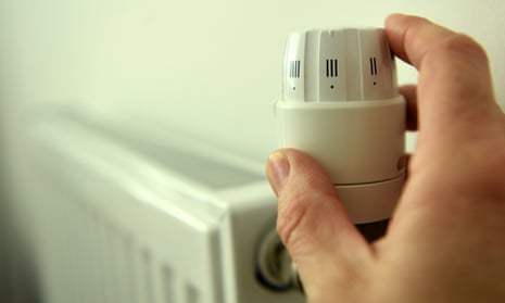 a householder turns down the radiator dial