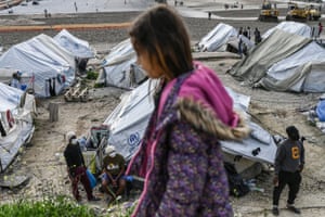 A child walks past tents at Kara Tepe refugee camp on Lesbos.