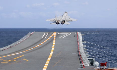 A J-15 Chinese fighter jet takes off from the Shandong aircraft carrier during military exercises around Taiwan on 9 April