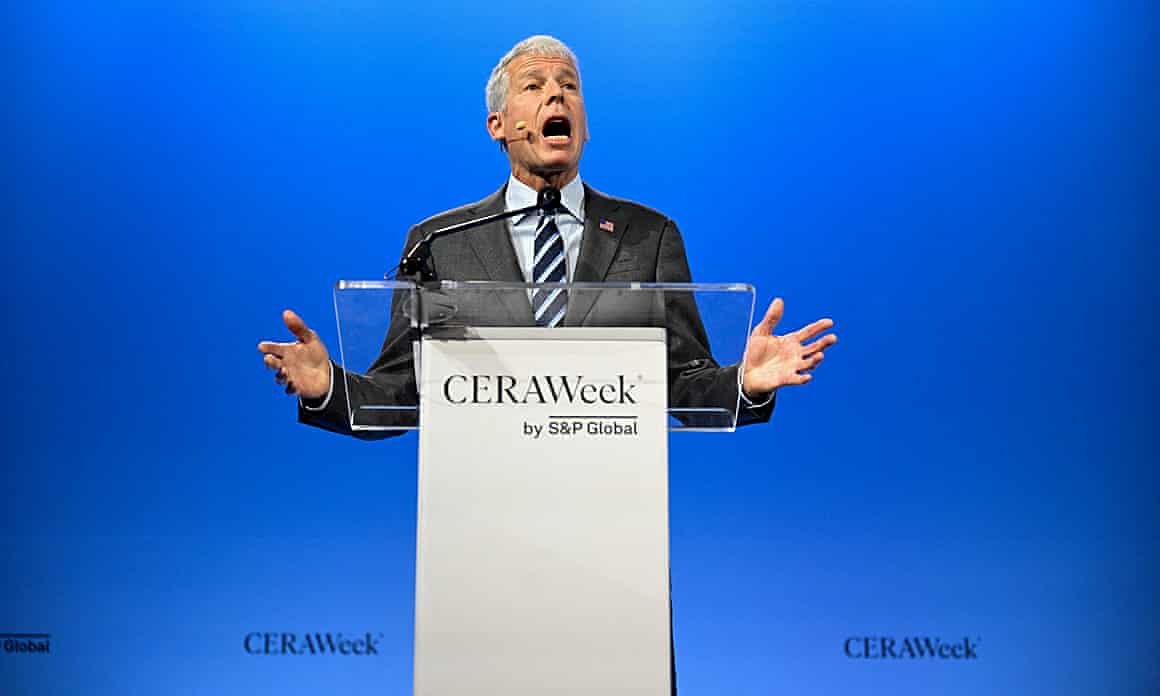 Wright gestures as he delivers a speech from behind a lectern