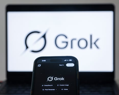 A laptop and smartphone displaying the Grok logo and branding