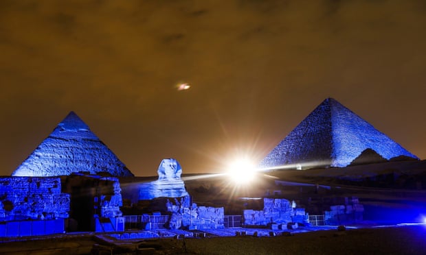 The Great Pyramids of Giza is lit up blue in Giza, Egypt
