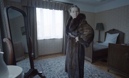 Sandra Hüller as Hedwig Höss in The Zone of Interest, trying on the fur coat of a murdered Jewish captive