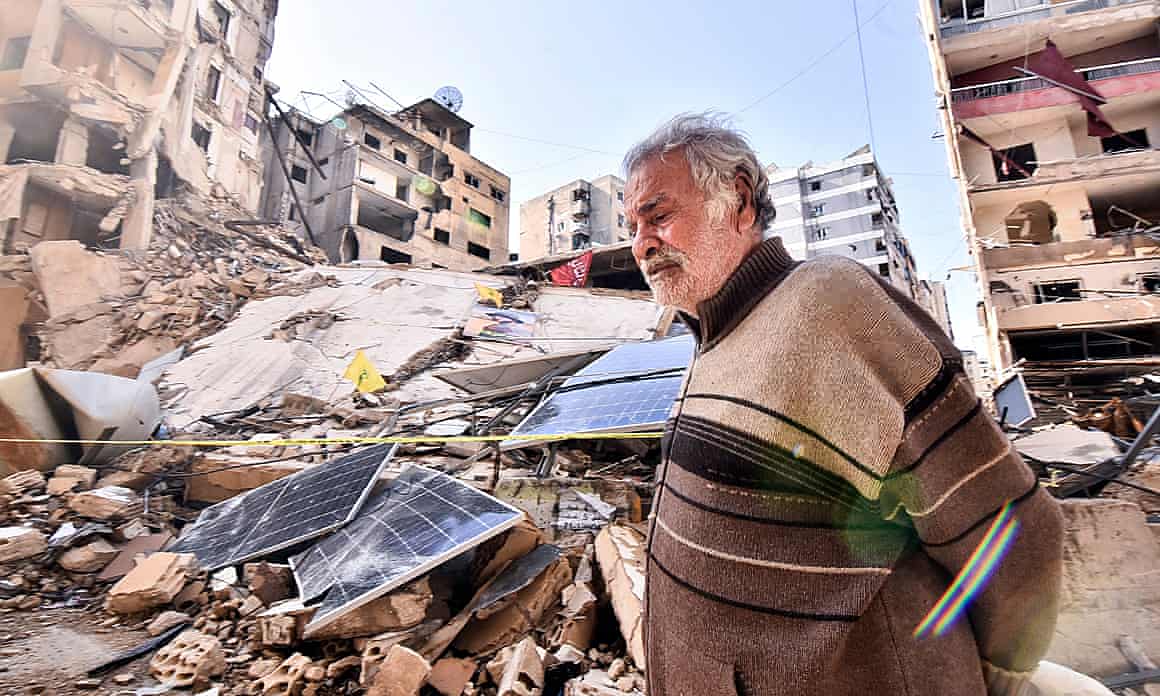 A man walks through the rubble of destroyed buildings in Beirut