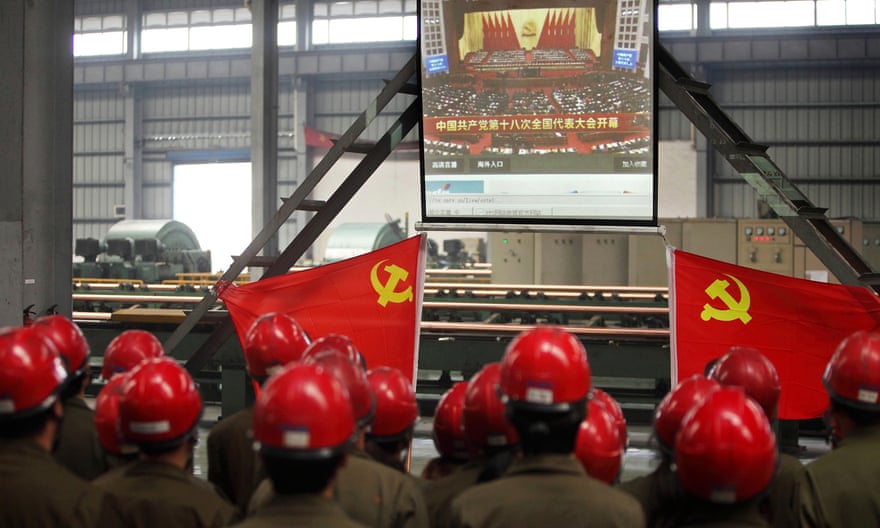 Workers in Zhijiang watch a live broadcast of the Communist party congress as Xi Jinping prepares to take power, November 2012