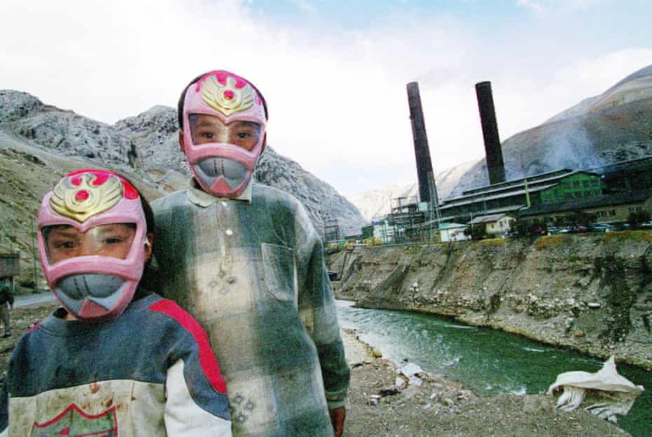 Children wearing masks play near the poly-metal smelter in La Oroya, owned by the US company Doe Run, in Peru’s central Andes. This photo was taken in 2000.