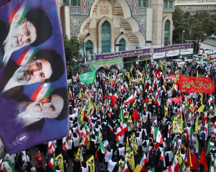 People from Tehran gather in support and allegiance to the new leader, Seyyed Mojtaba Khamenei, while holding the Iranian flag and images of both the new and former leaders of Iran.