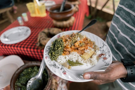 Close-up of a man holding a traditional African dish