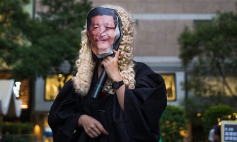A protester wears a President Xi mask at a rally in support of the jailed Hong Kong three. Photograph: Billy HC Kwok/Getty Images