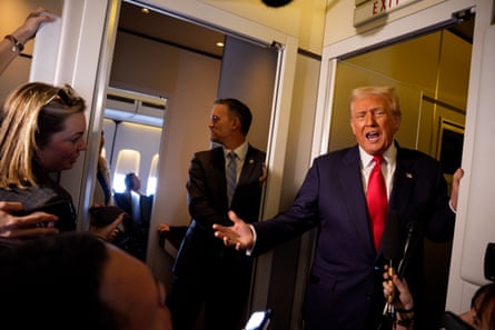 Greer stands in the background as Trump speaks and gestures