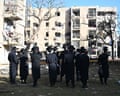 Crowd of people look at damaged apartment buildings in Ramat Gan after an Iranian missile strike on 22 March.