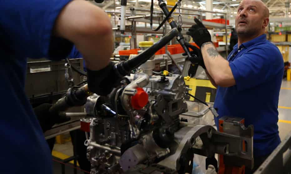 An employee works on an engine production line at a Ford factory in Dagenham