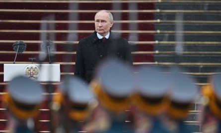 Vladimir Putin in the background with soldiers in the foreground