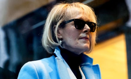 White woman wearing sunglasses and blue coat.