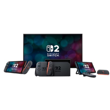 The Nintendo Switch 2 console docked beneath a television, with two handheld devices and detachable controllers