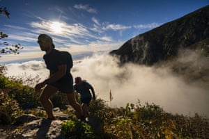 Mount Washington, US: Hikers ascend through clouds as they head to the summit of the 6,288-ft mountain in New Hampshire. A high-pressure system brought pleasant conditions to climbers on the first weekend of October