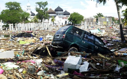 a car amid debris in front of a mosue