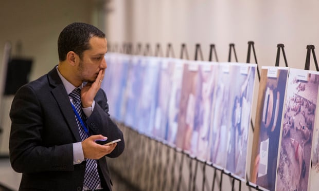 A man reacts as he looks at some of Caesar’s photographs, at the UN in New York.